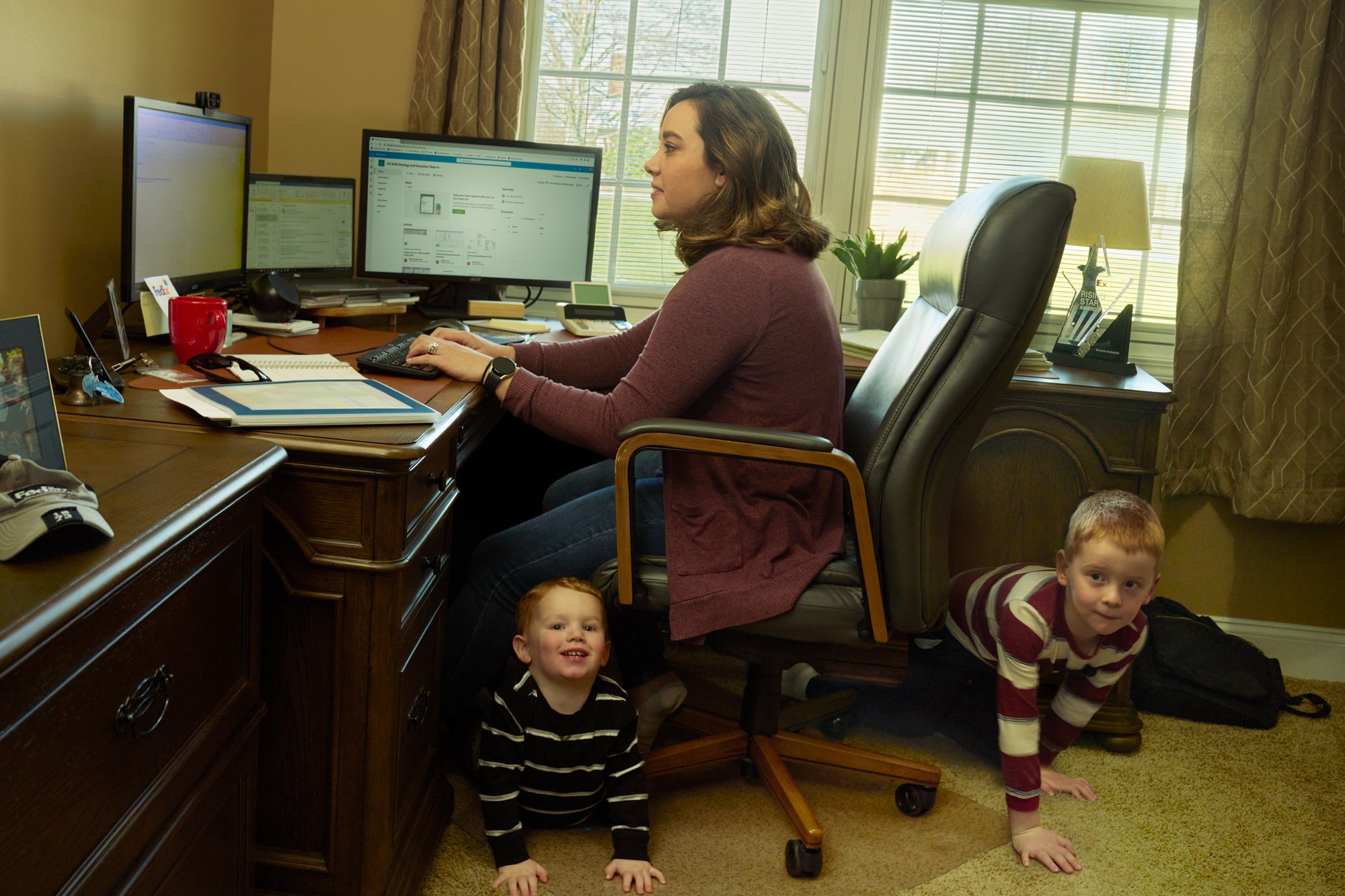 FedEx team member Marianne Senkowski at her home office with her sons