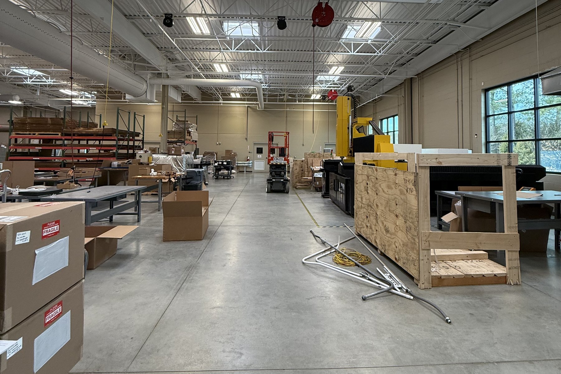 A lab floor with cartons marked fragile, crates and test equipment