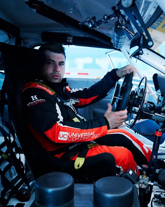 A Bryan Herta Autosport driver in the cockpit of a Hyundai N race car