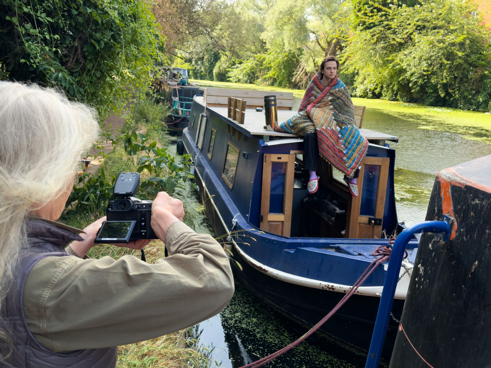 Annie Leibovitz photographs a woman seated on the roof of a canal narrowboat in the UK