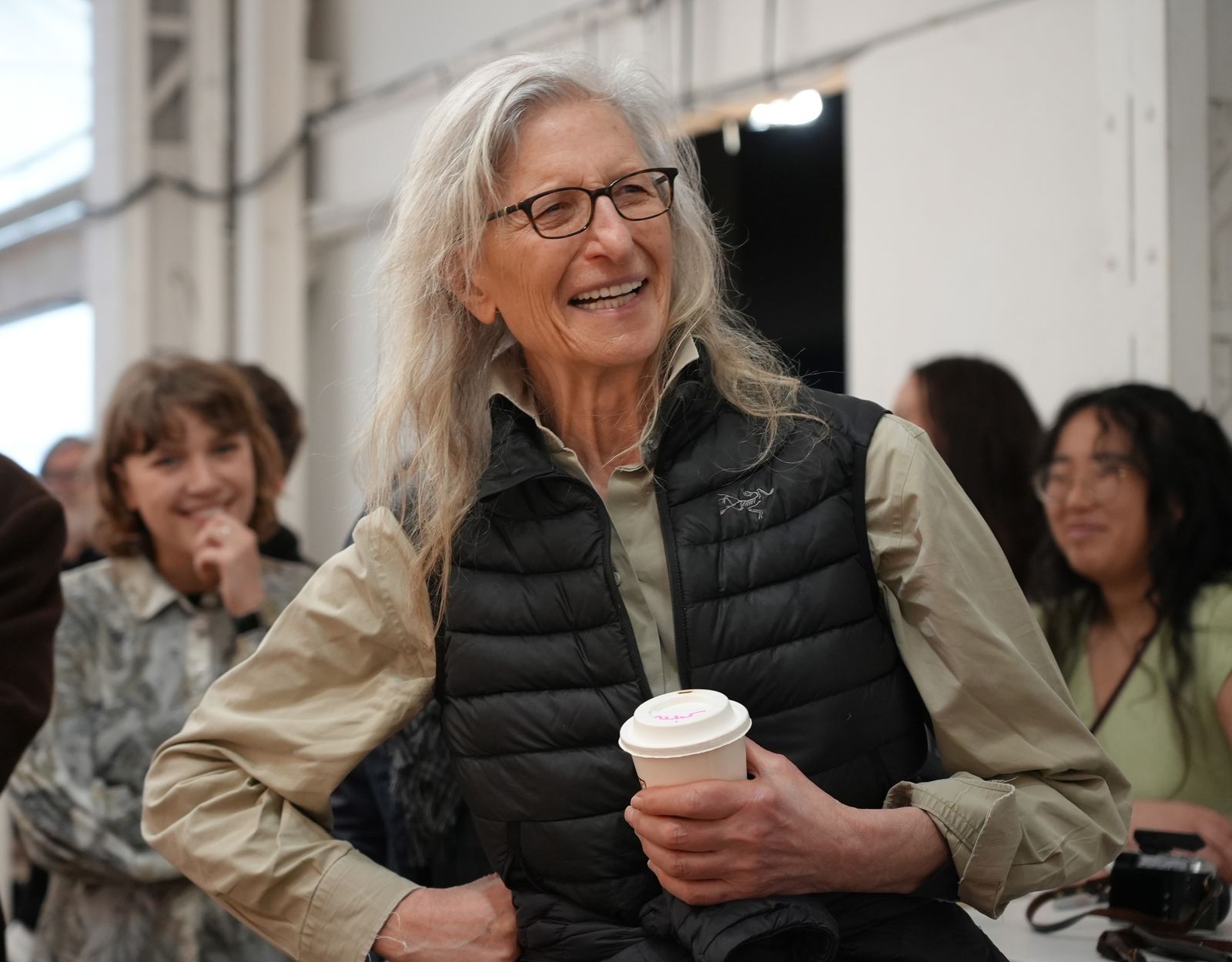 Annie Leibovitz laughs with guests, coffee in hand, at the IKEA+ launch