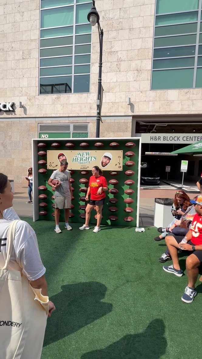 Fans in the football-wall photo booth