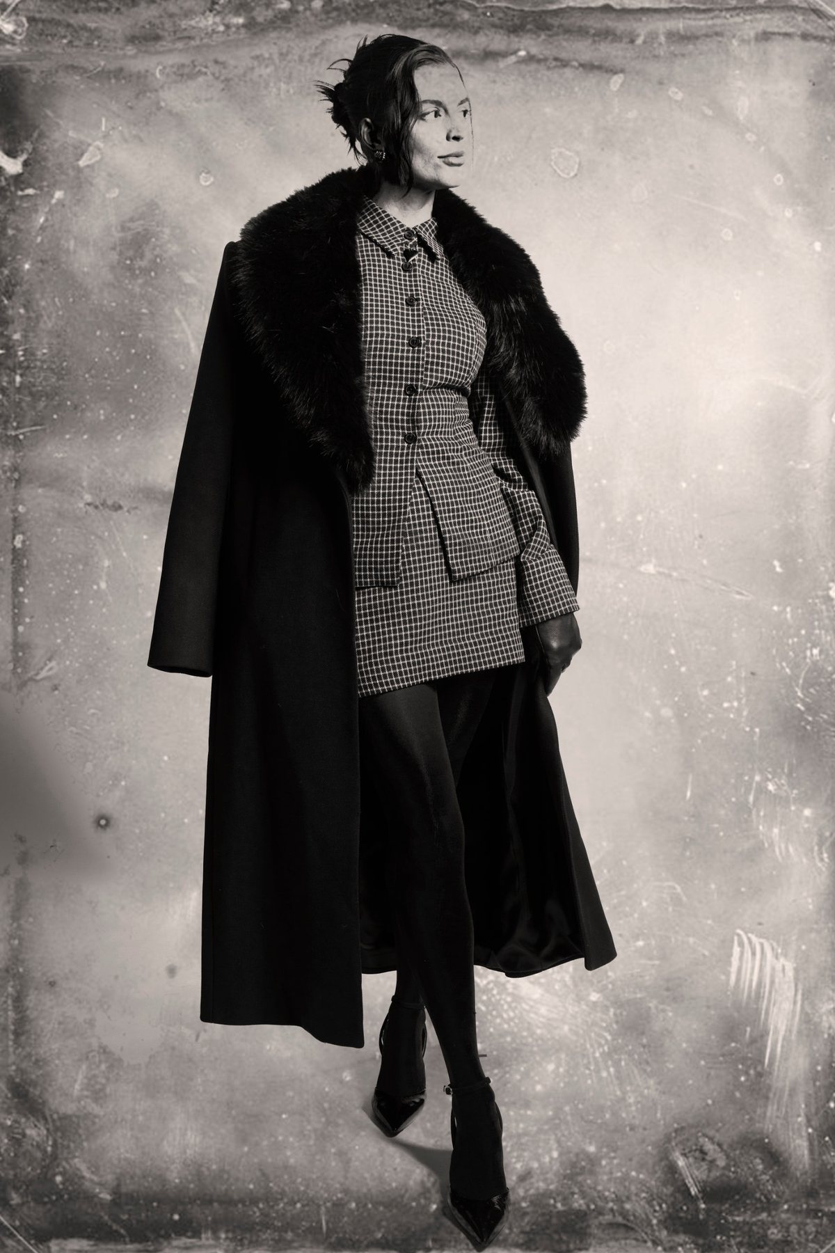 A creator in a fur-collared long coat over a checked jacket, finished as a tintype portrait