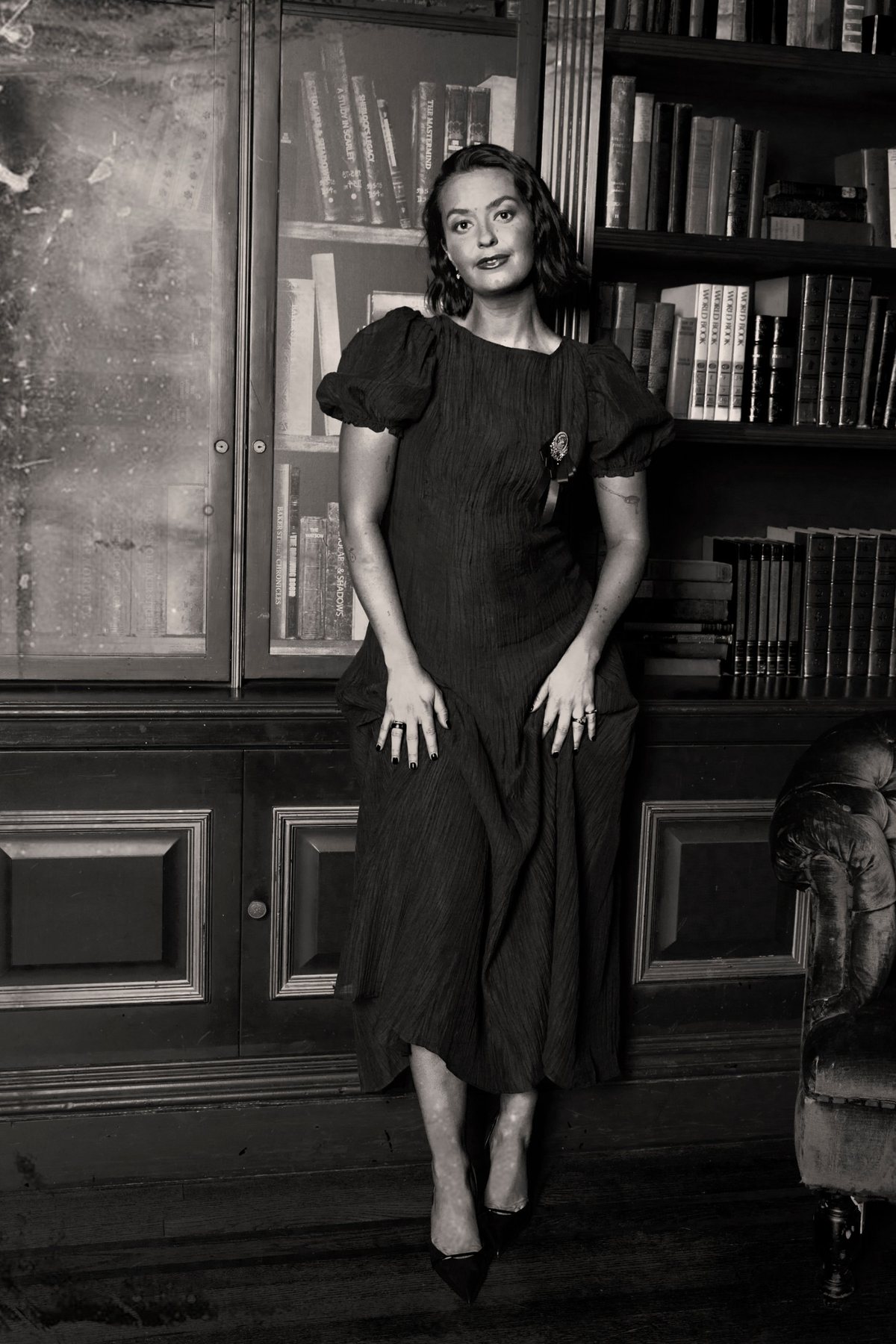 A creator in a puff-sleeve dress in the library