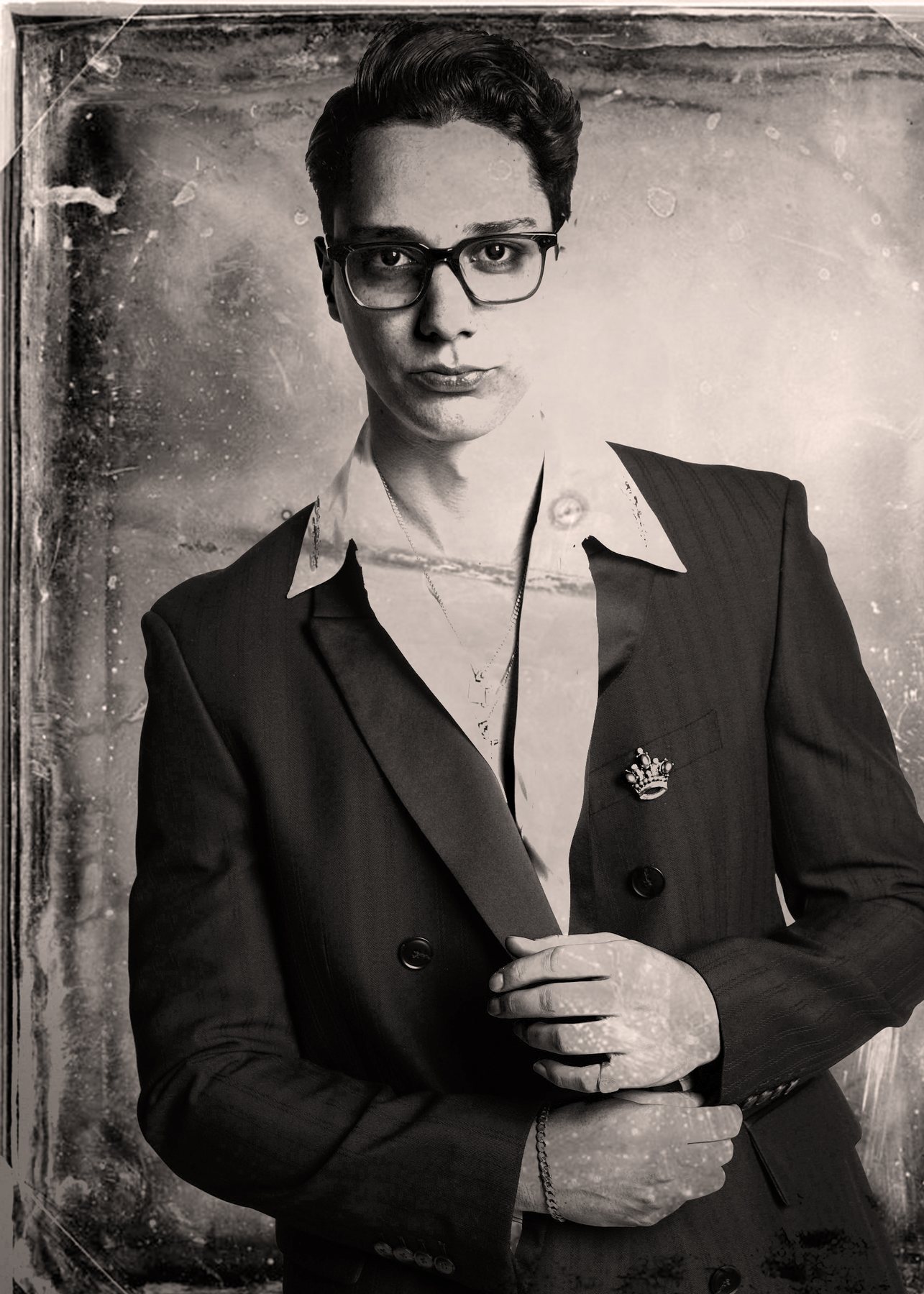 A creator in glasses and a double-breasted jacket with a crown brooch, finished as a tintype portrait