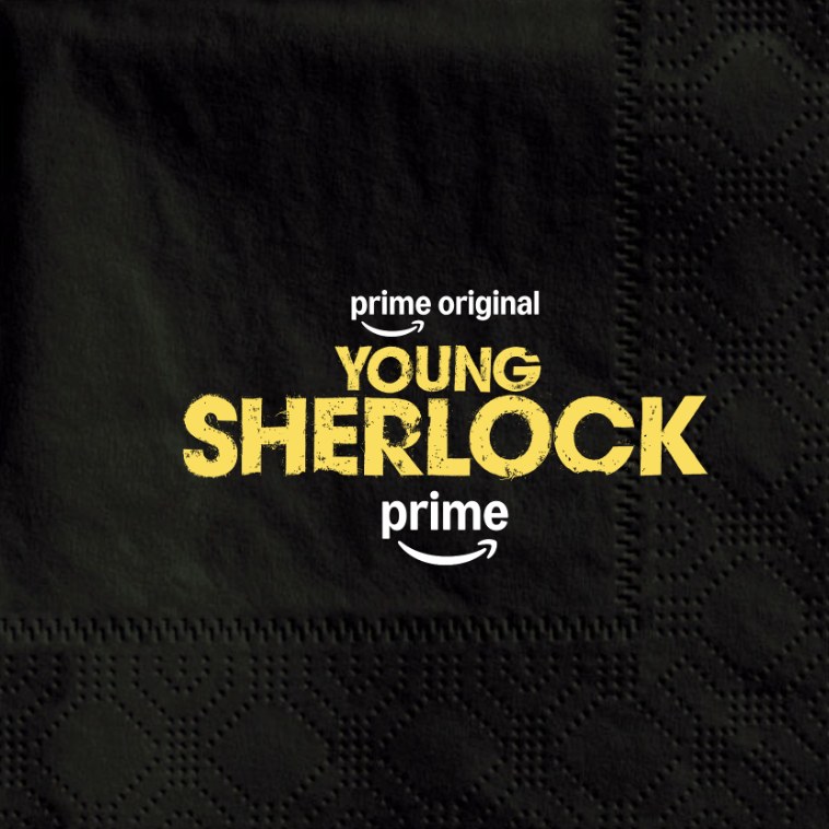 A black cocktail napkin printed with the Young Sherlock logo