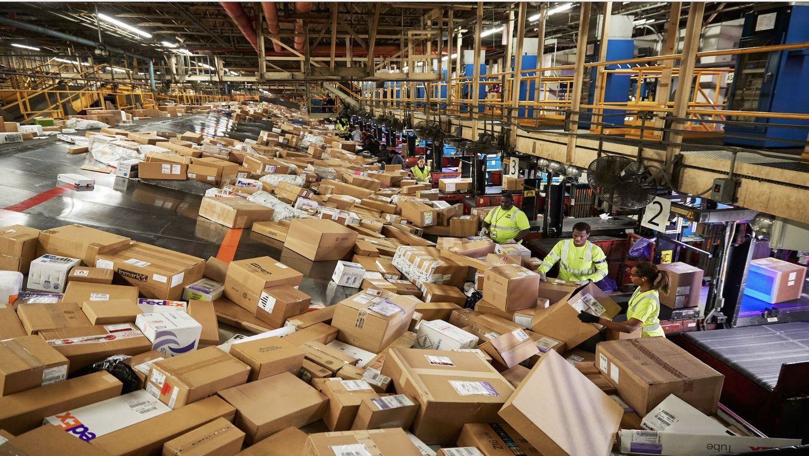 Workers sorting parcels in a FedEx facility