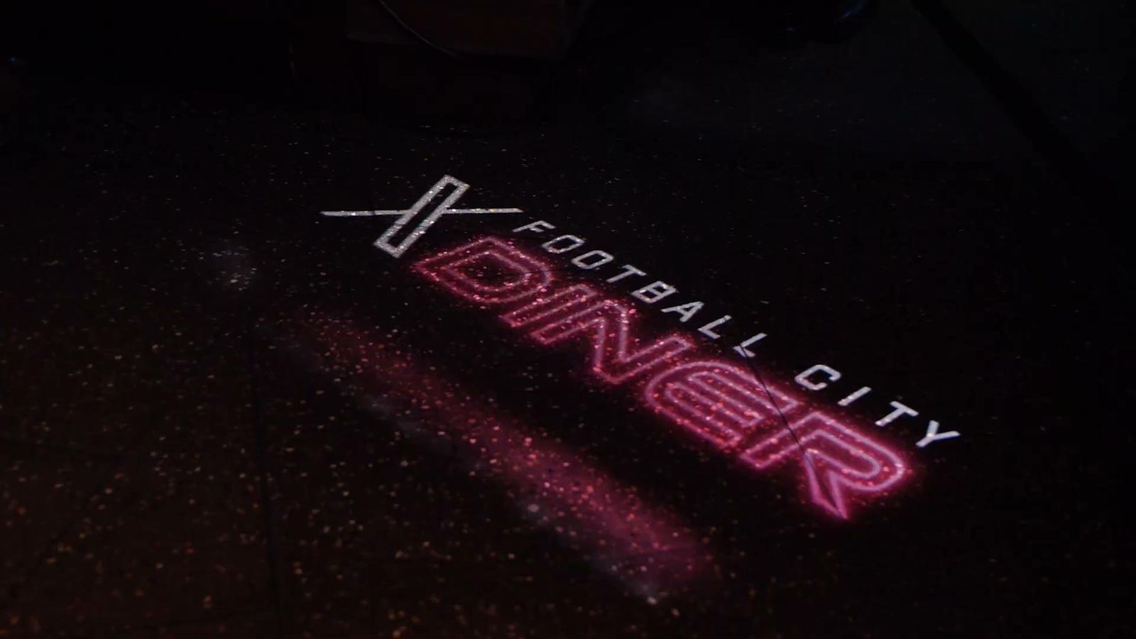 X Football City Diner logo projected on the floor